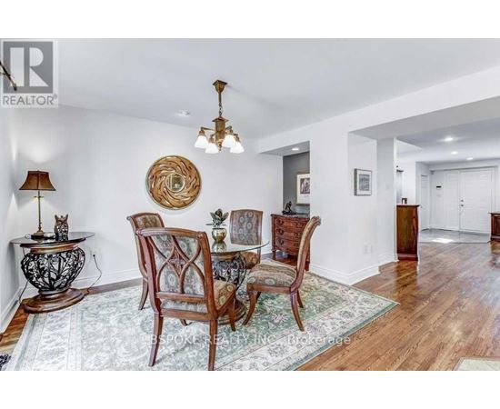 A dining room with a wooden table and chairs.