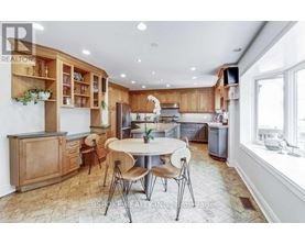 A kitchen with wooden cabinets and a tiled floor.