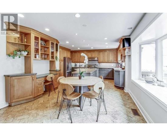 A kitchen with wooden cabinets and a tiled floor.