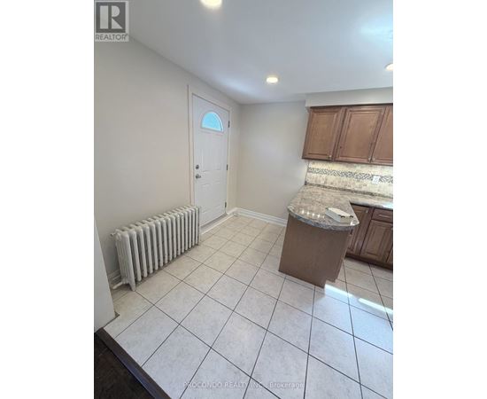 A room with a white tile floor and a white door.