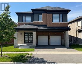 A two-story house with a garage and a brick facade.