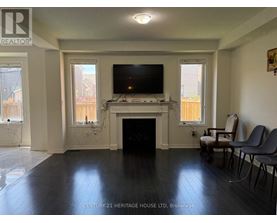 A living room with a fireplace and a television.