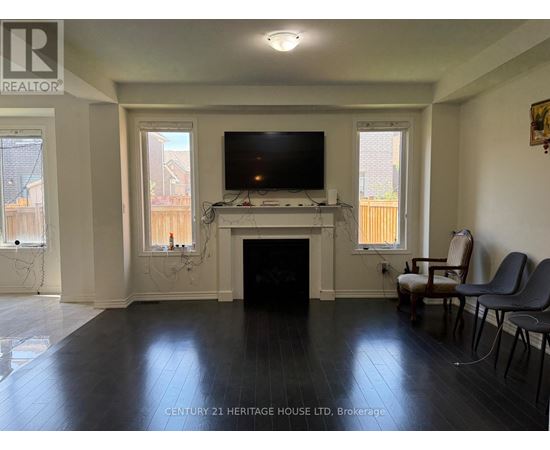 A living room with a fireplace and a television.