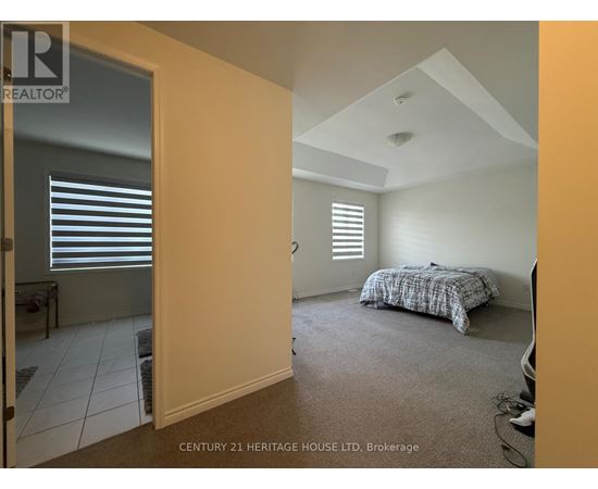 A bedroom with a bed and a window with blinds.