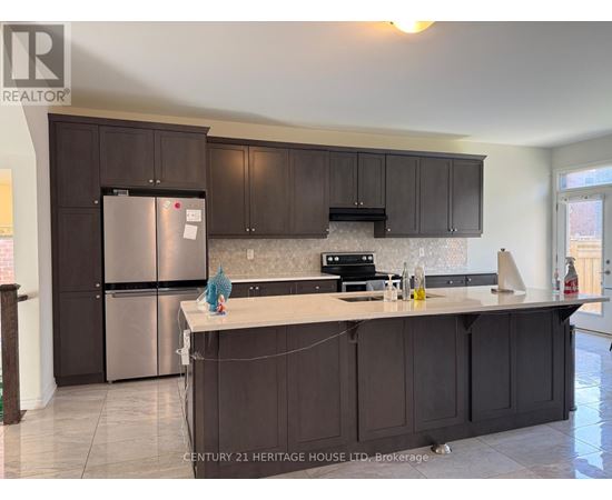 A kitchen with dark brown cabinets and a stainless steel refrigerator.