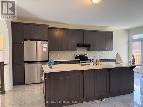A kitchen with dark brown cabinets and a stainless steel refrigerator.