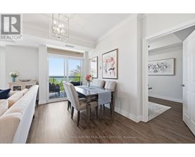 A dining room with a table set for four and a couch.