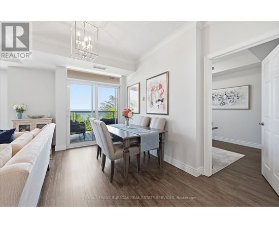 A dining room with a table set for four and a couch.