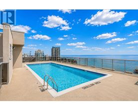 A pool on a balcony with a view of the city.