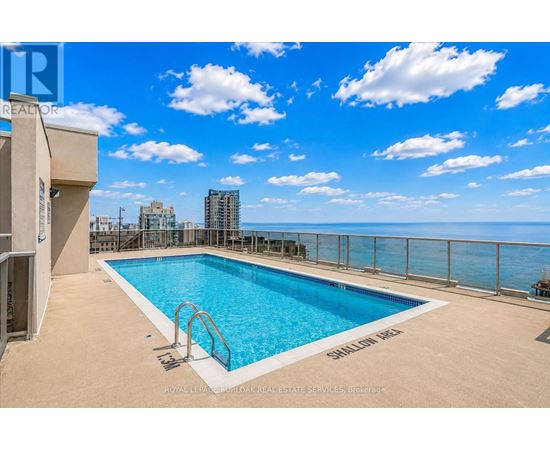 A pool on a balcony with a view of the city.