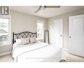 A bedroom with a large bed and a ceiling fan.