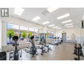 A gym with exercise equipment and a large window.