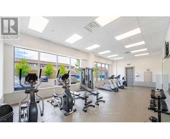 A gym with exercise equipment and a large window.
