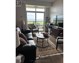 A living room with a view of the ocean.
