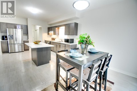 A modern kitchen with a dining table set for two.