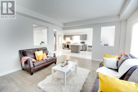 A living room with a brown leather couch and a white coffee table.
