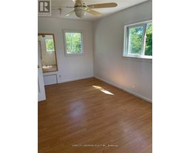 A room with wooden floors and a ceiling fan.