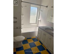 A bathroom with a toilet, sink, and bathtub.