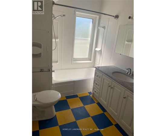 A bathroom with a toilet, sink, and bathtub.