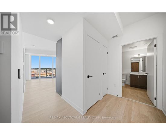 A spacious room with a view of a balcony and a door leading to another room.