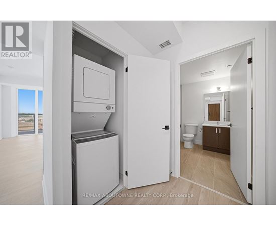 A white refrigerator is in a kitchen with a door open.