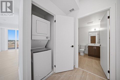 A white refrigerator is in a kitchen with a door open.