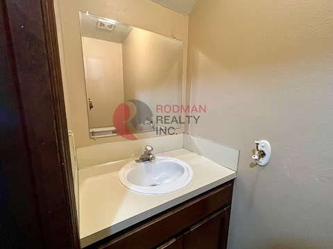 A bathroom sink with a mirror above it.