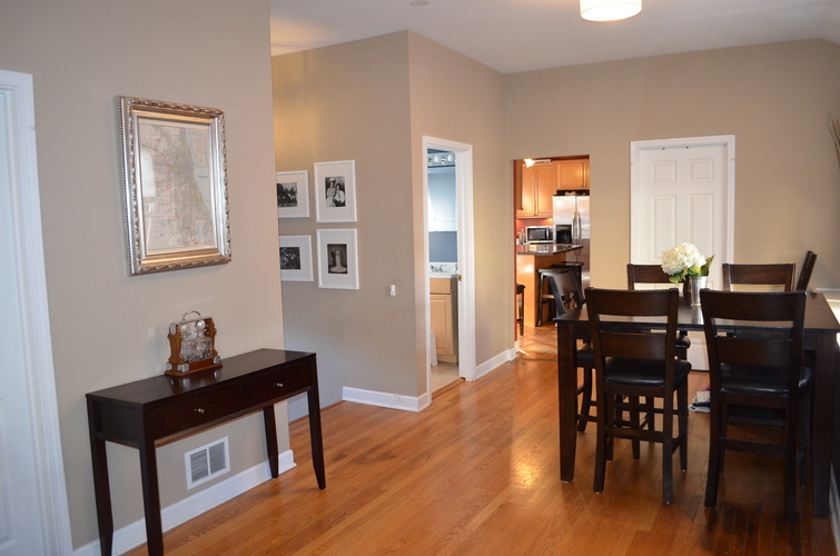 A dining room with a table and chairs.