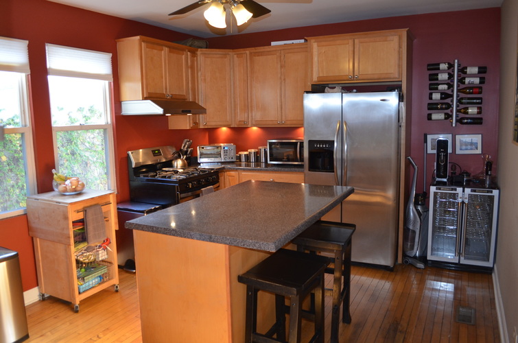 A kitchen with wooden cabinets and a granite countertop.