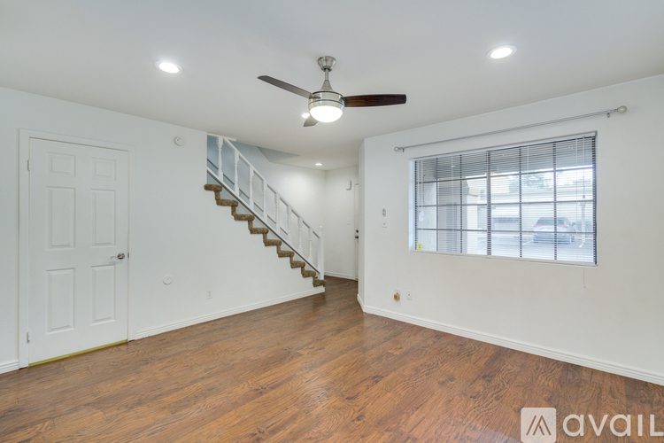 A room with a staircase and a window.