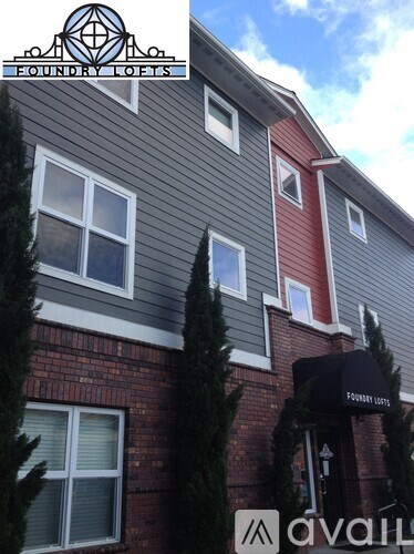 A building with a sign that says "Foundry Lofts" on it.
