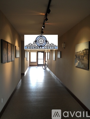 A long hallway with a sign that says "Efoundry Lofts" on the wall.