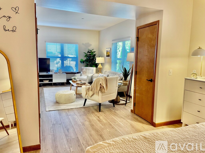 A bedroom with a bed, dresser, and a mirror.
