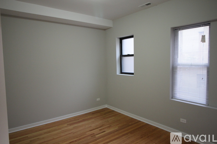A room with a window and wooden flooring.