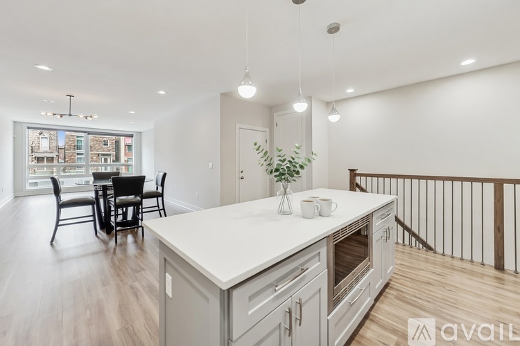 A modern kitchen with a dining table and chairs.