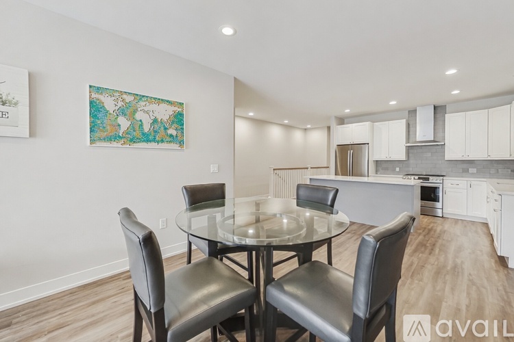 A dining room with a glass table and chairs.