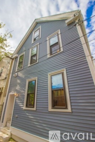 A blue house with a sign that says "available" in front of it.