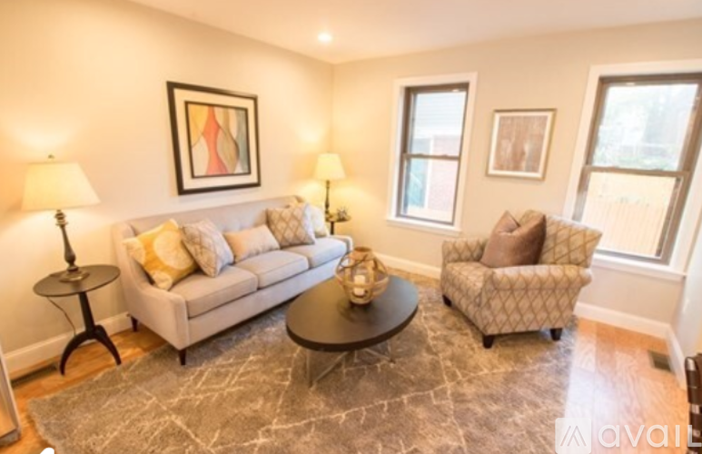 A living room with a couch, chair, and a coffee table.