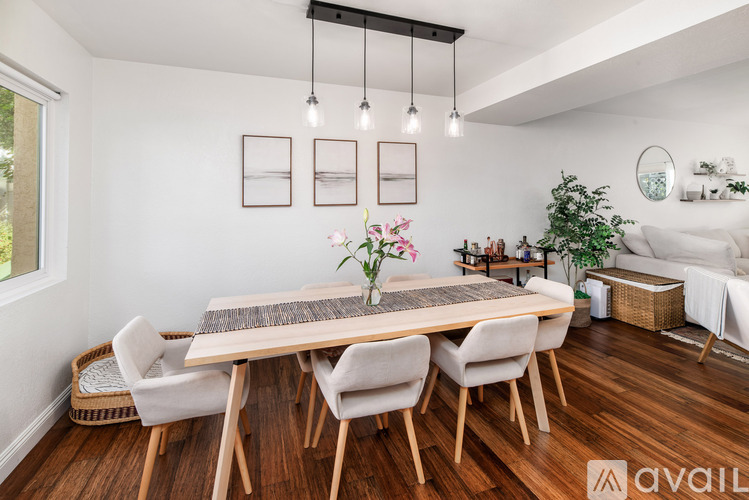 A dining room with a wooden table and chairs.