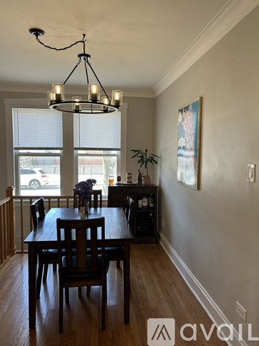 A dining room with a wooden table and chairs.