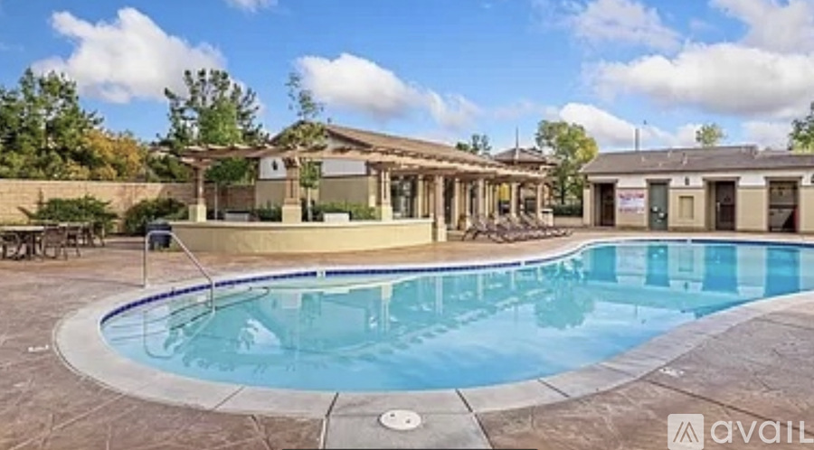A large outdoor swimming pool surrounded by a patio area.
