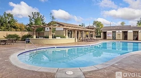 A large outdoor swimming pool surrounded by a patio area.