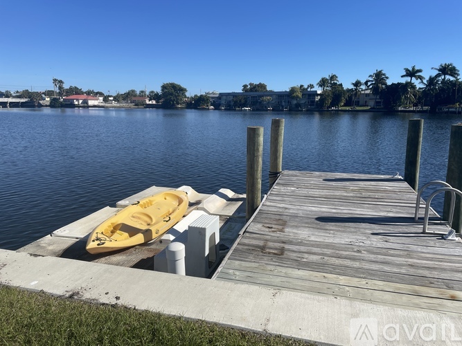 A yellow kayak is docked at a wooden pier.