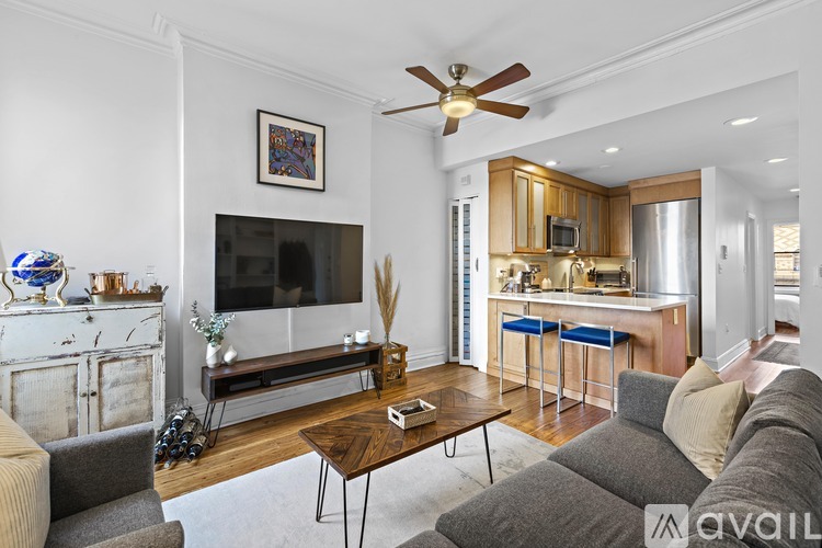 A living room with a grey couch and a wooden coffee table.