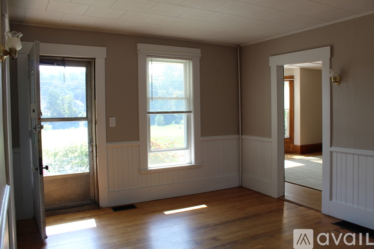 A room with two windows and a door.