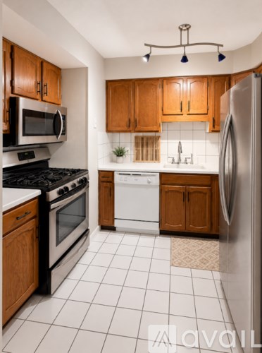A kitchen with wooden cabinets and white appliances.