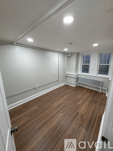 A room with wooden floors and white walls.