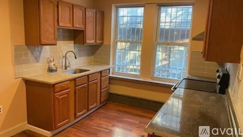 A kitchen with wooden cabinets and a window.