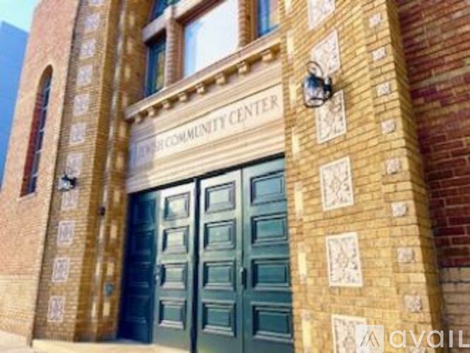 A brick building with a green door and a sign that says "Community Center".