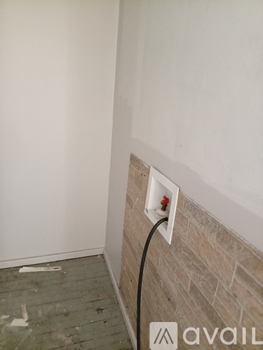 A white electrical outlet with a red light on it.